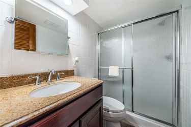 Guest bathroom with walk-in shower and seat