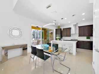Dinette convenient to the kitchen with triple sliders leading to the outdoor lanai and pool area per