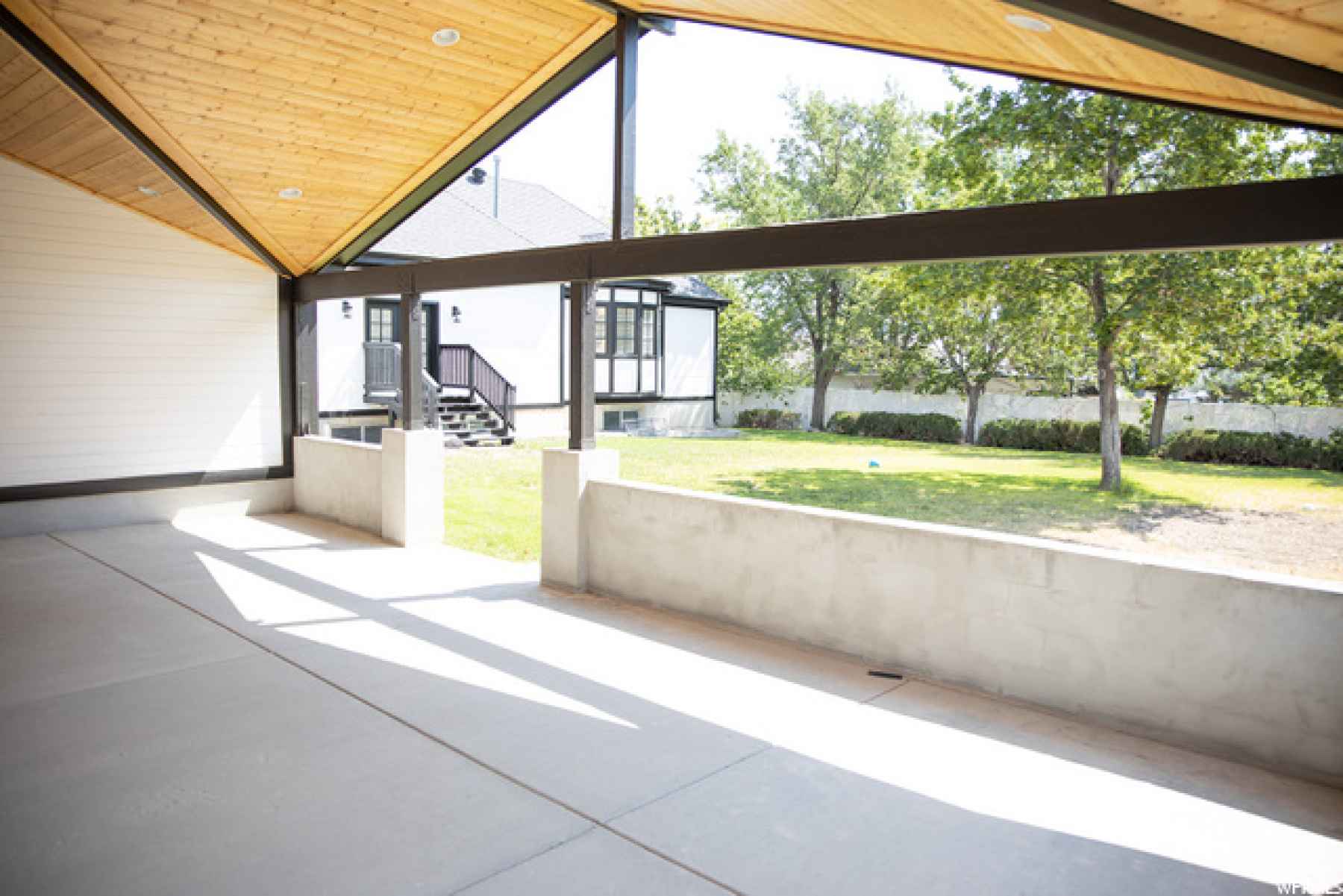 Beautiful covered patio with vaulted natural wood ceiling and recessed lighting! this would be a great pool house apartment and deck if you wanted to add a pool in the backyard!