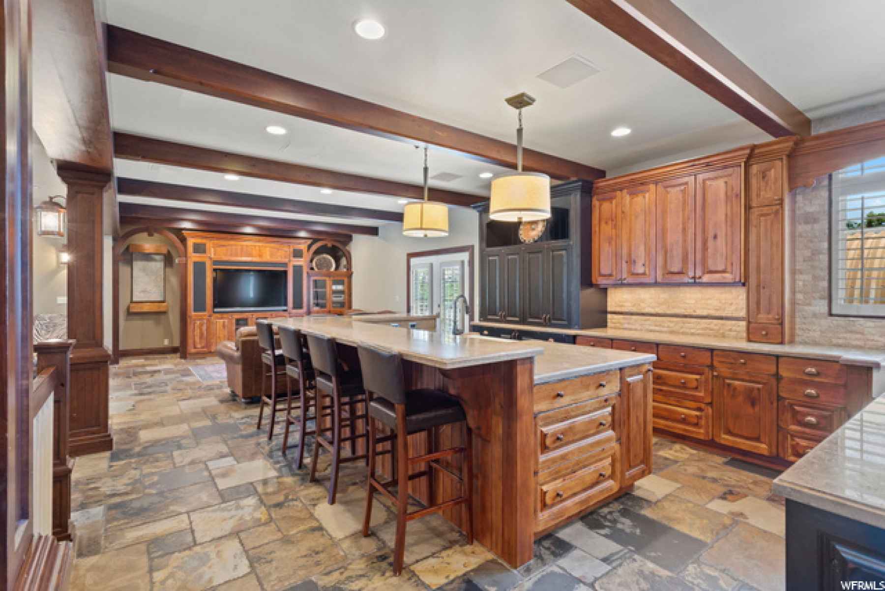 You will love this gourmet kitchen with two work spaces and large snack bar! Built in warming oven, wolf double oven, sub zero fridge!