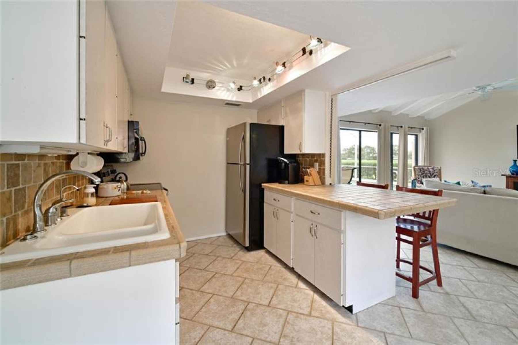 Open Kitchen with Breakfast Bar and Eat-in-Area.  Wood Cabinets, Stone Counter Tops, Stainless Appli