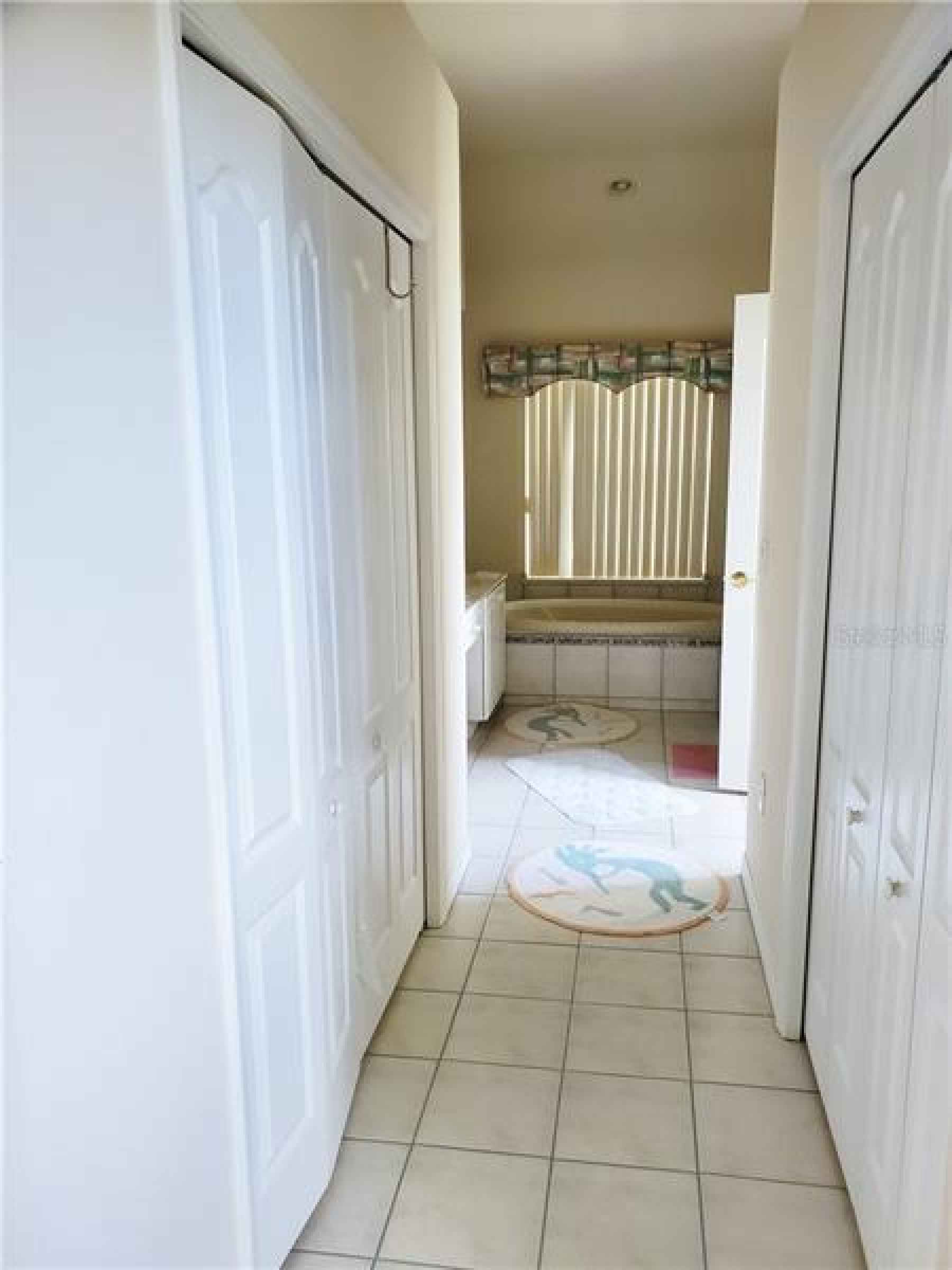 Hallway to Master Bath with His/her Closets