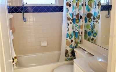 Complete bathroom with tub and shower combo between bedrooms