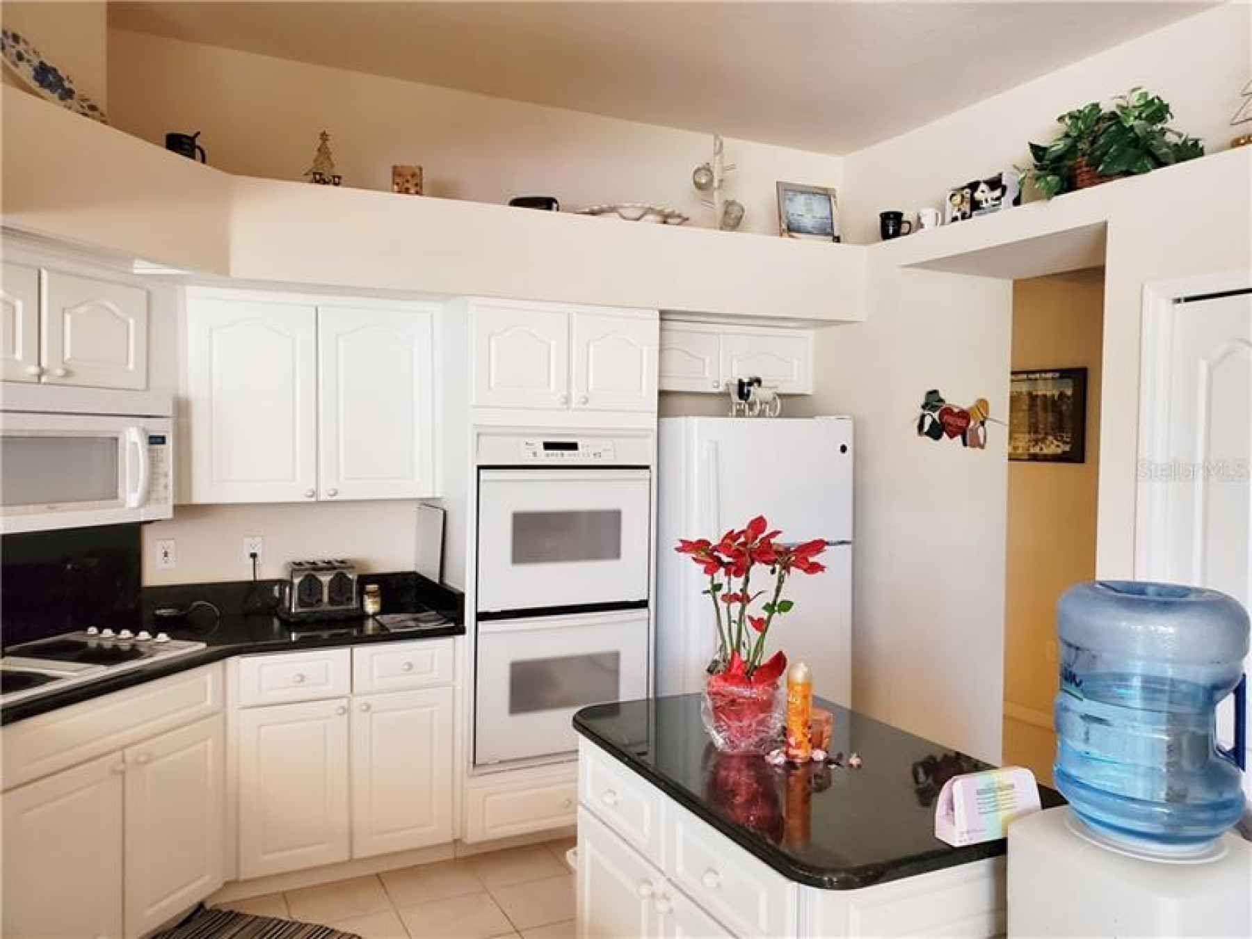 Kitchen with double oven and island.  Kitchen also has desk area and plenty of cabinet space