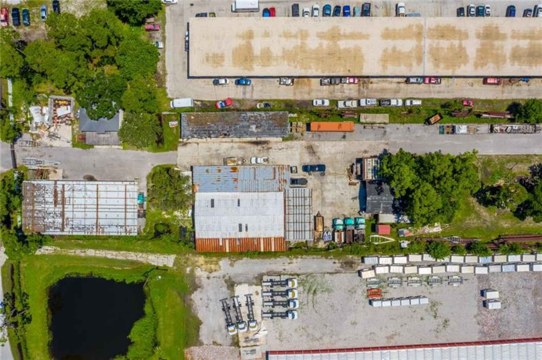 Aerial of Warehouse and Covered Storage on Bottom and SFR on Top of Photo