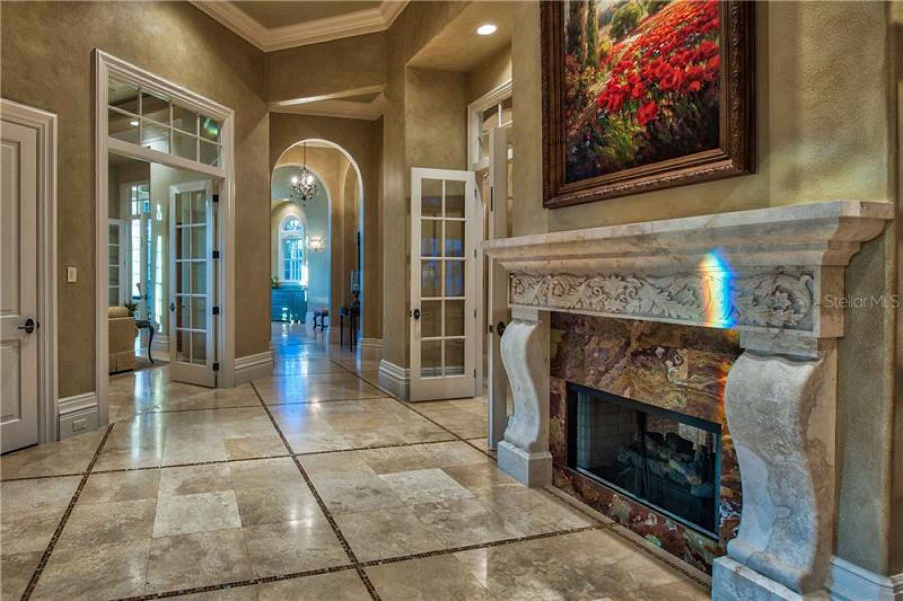 Marble Flooring with Mosaic Tile Inlays and Grande French Doors
