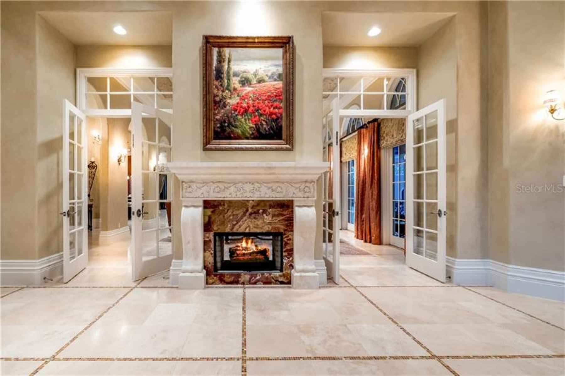 Double Sided Gas Fireplace between Foyer and Gathering Room