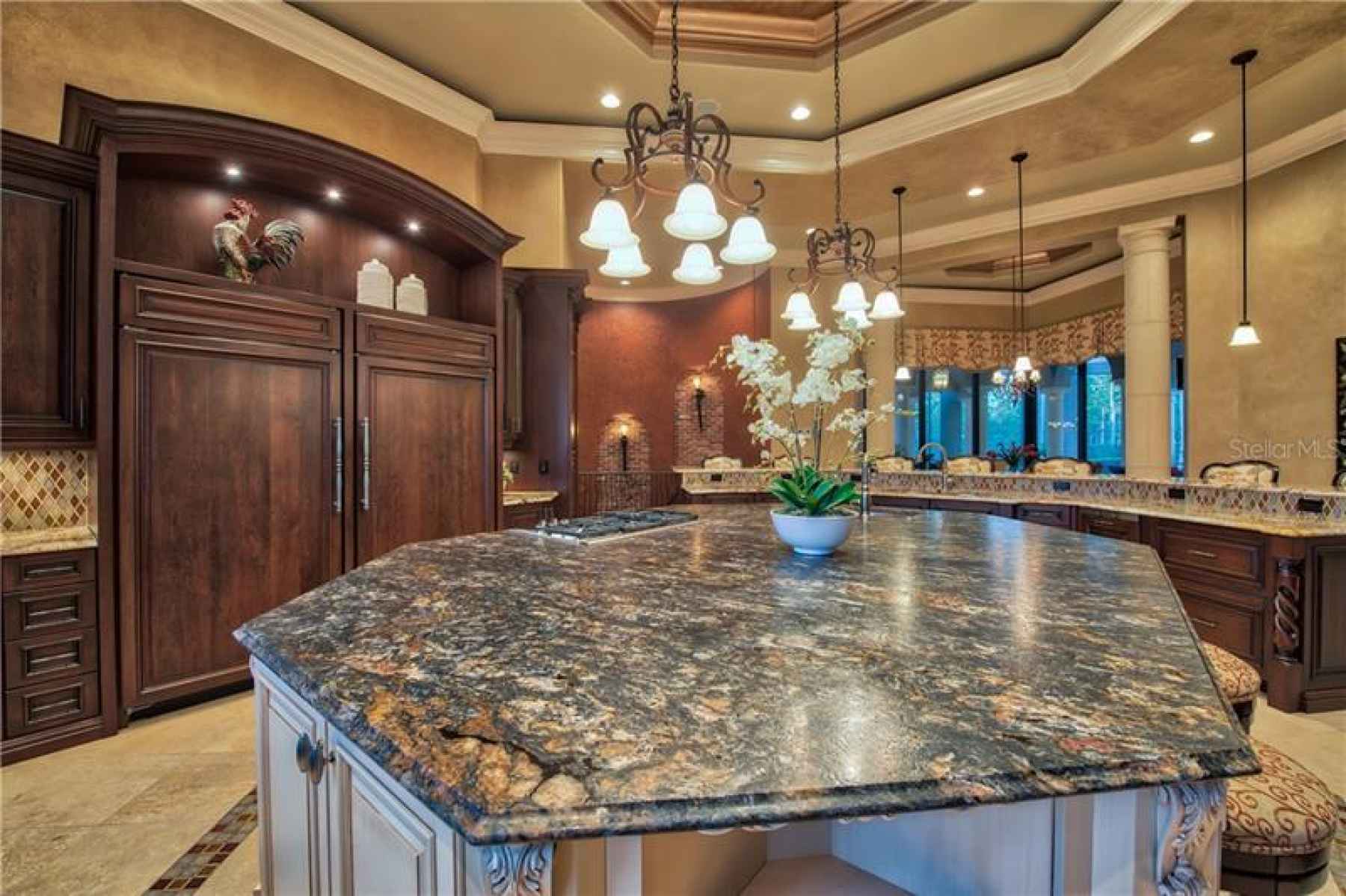 Center Island features Range and Leathered Granite Counters