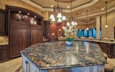 Center Island features Range and Leathered Granite Counters