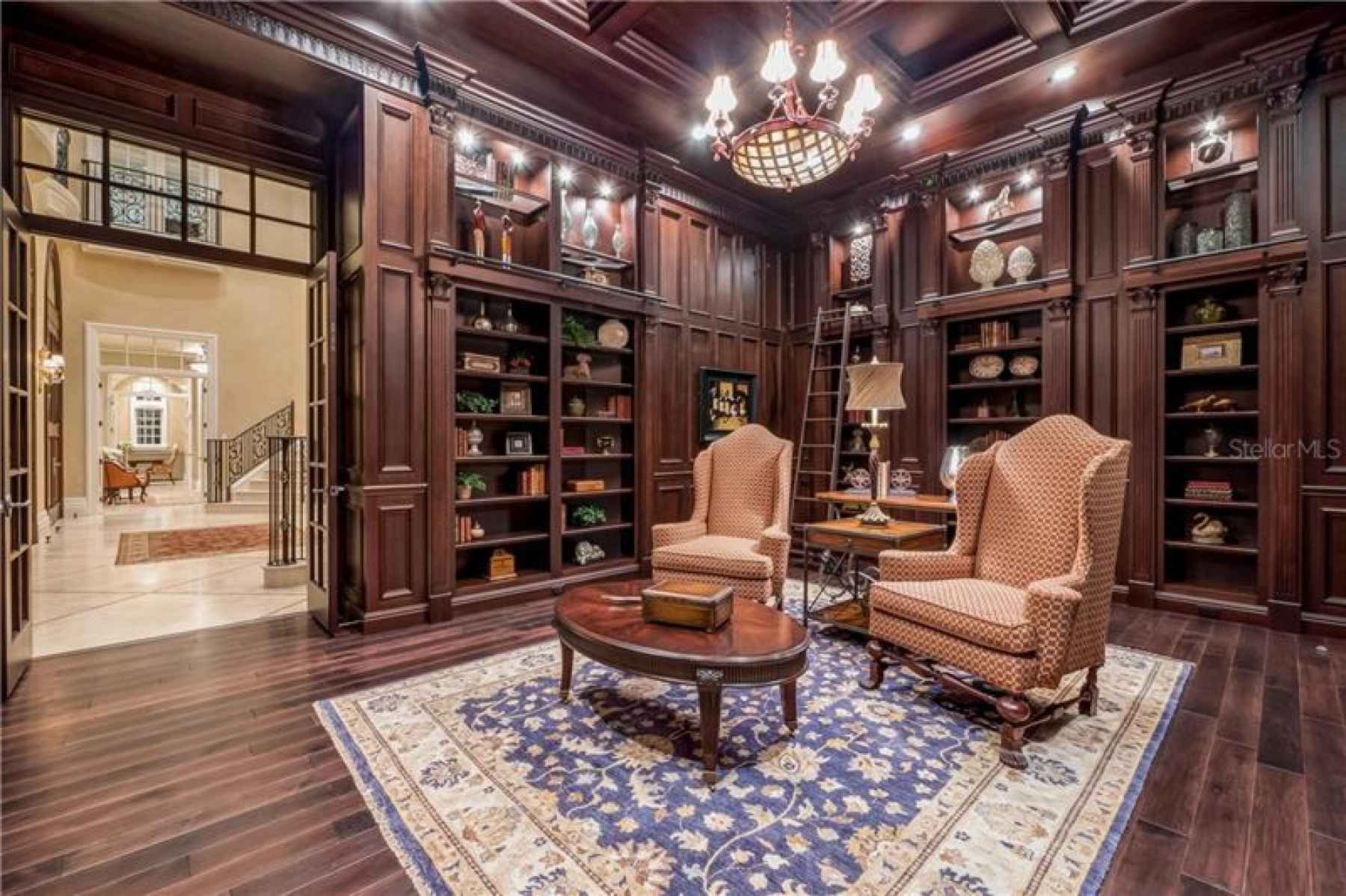 Library with Custom Shelving and Hardwood Flooring