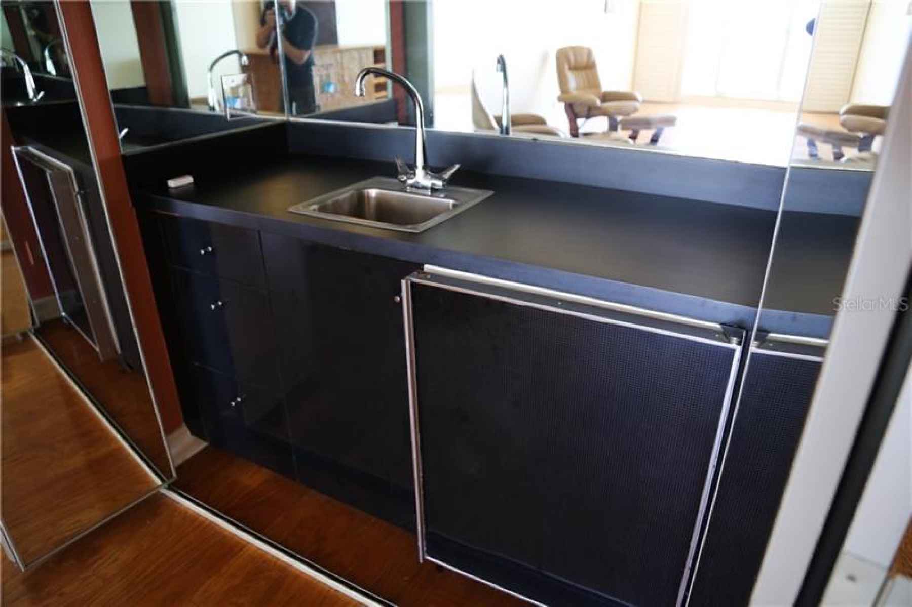 You can see the reflection of the views from this Wet Bar in the Living room