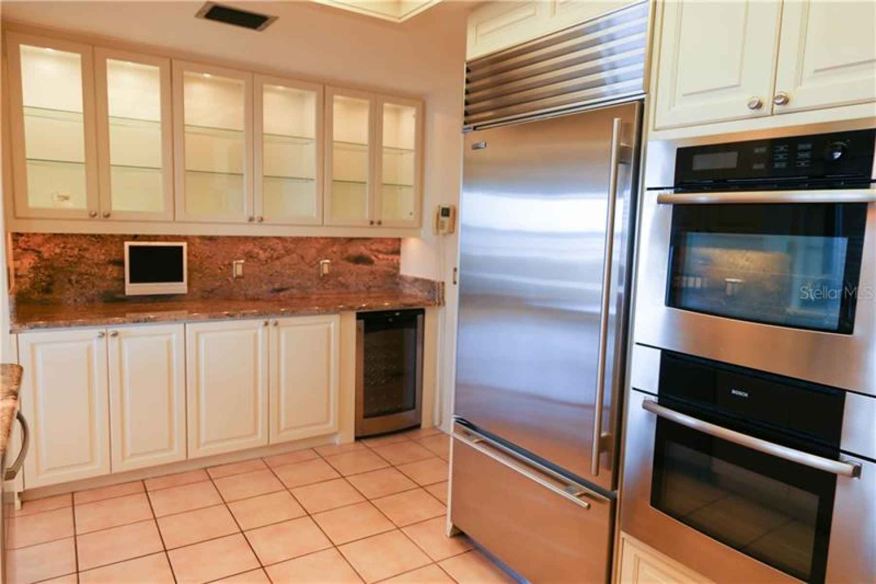 Kitchen with additional counter space and cabinetry and with Sub-Zero fridge and double ovens.