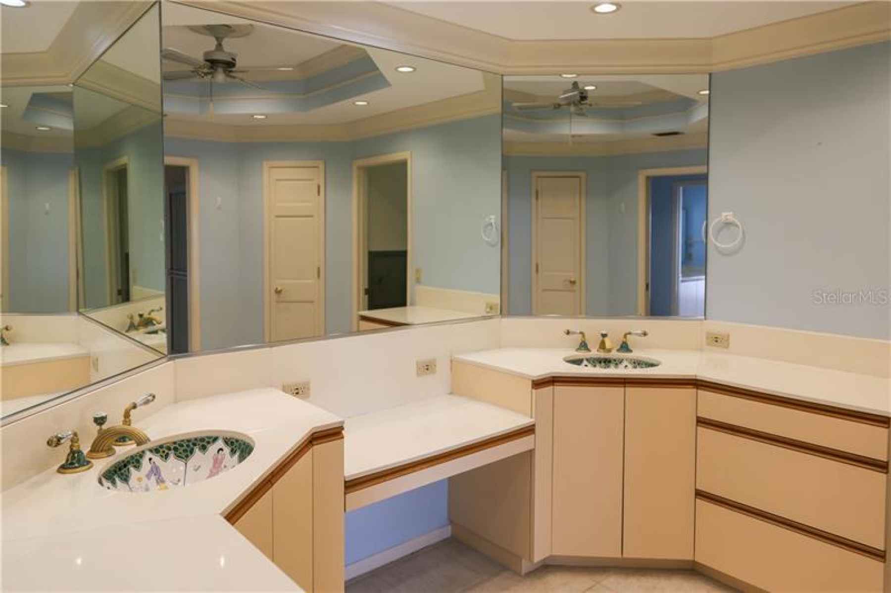Owner's bath with double sinks and vanity plus extra cabinets and counter space.