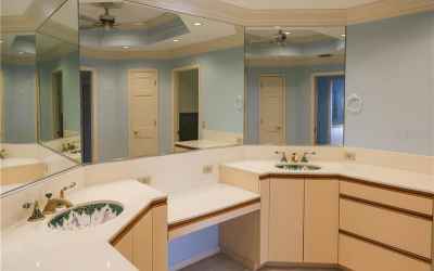 Owner's bath with double sinks and vanity plus extra cabinets and counter space.