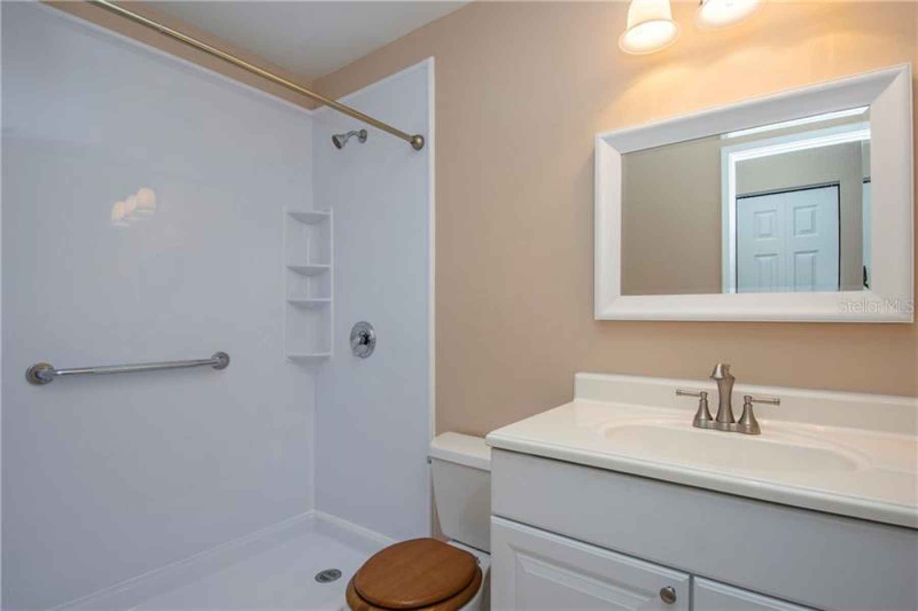 Updated Bathroom with walk-in shower with handicap handrails.