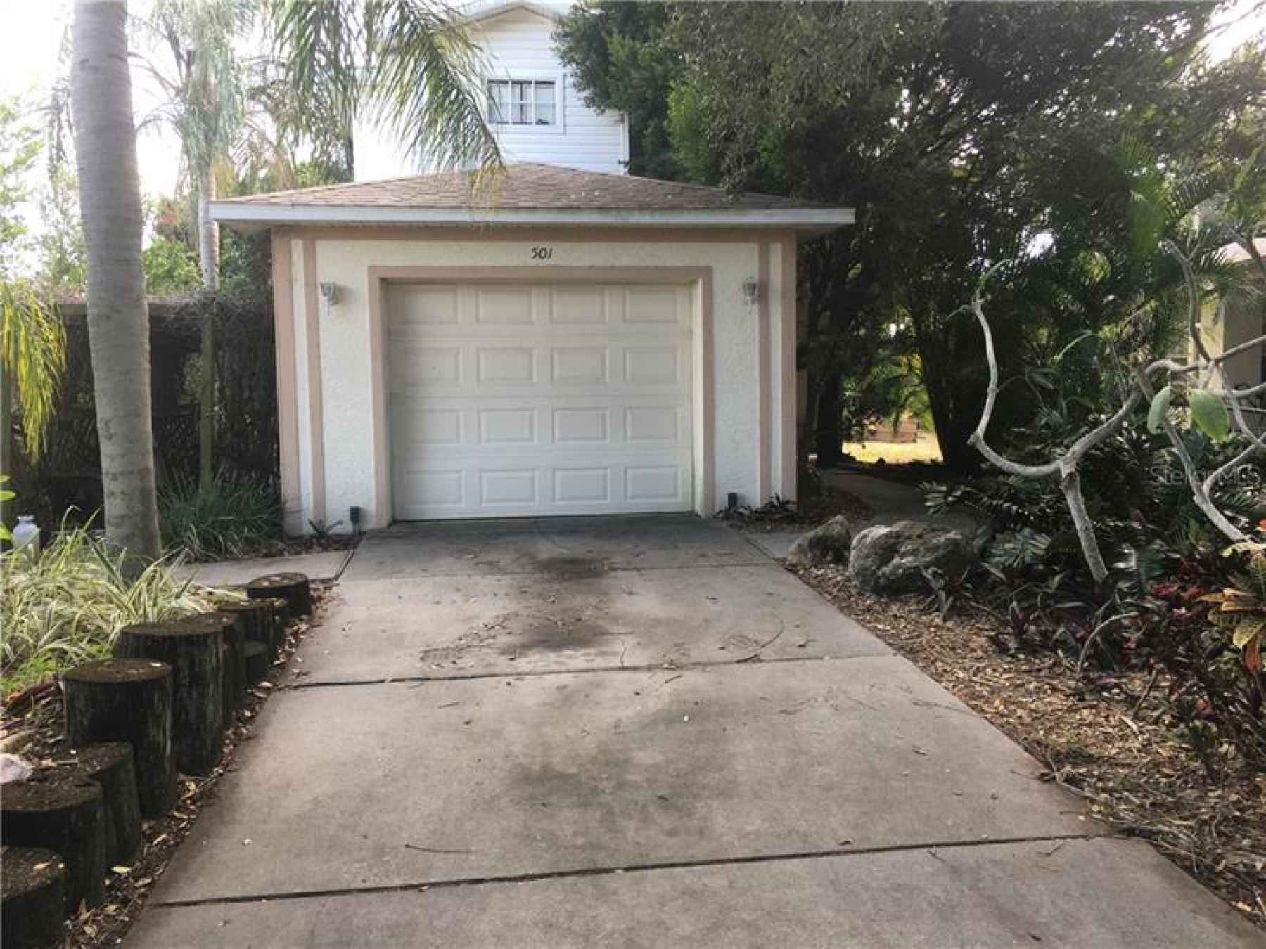 Path to right of garage leads to front door.