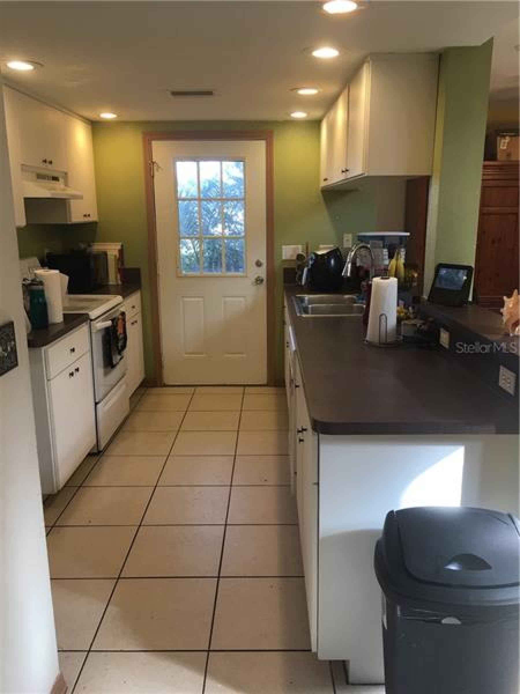 Kitchen with view of Side Door to house