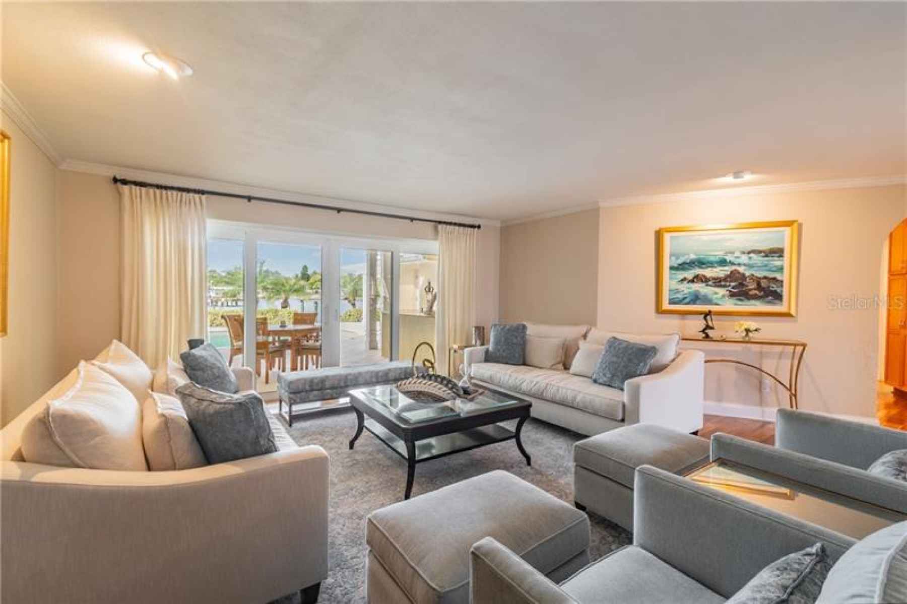 Living room overlooks lanai and waterfront.
