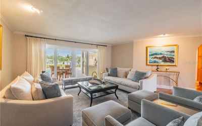 Living room overlooks lanai and waterfront.