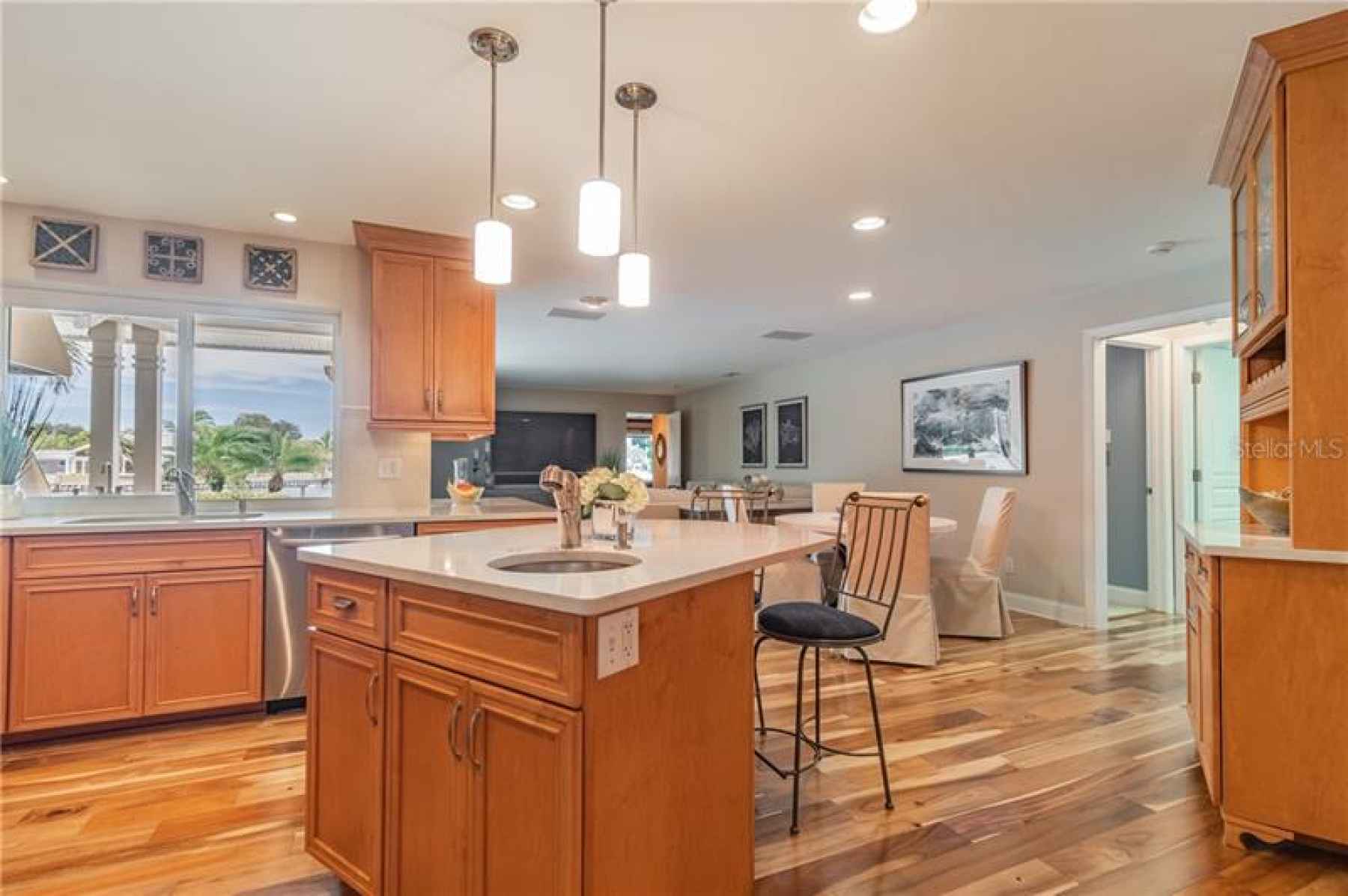 Kitchen/family room with views of sparkling waterfront and easy flow to out door living space, inclu