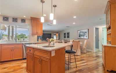 Kitchen/family room with views of sparkling waterfront and easy flow to out door living space, inclu