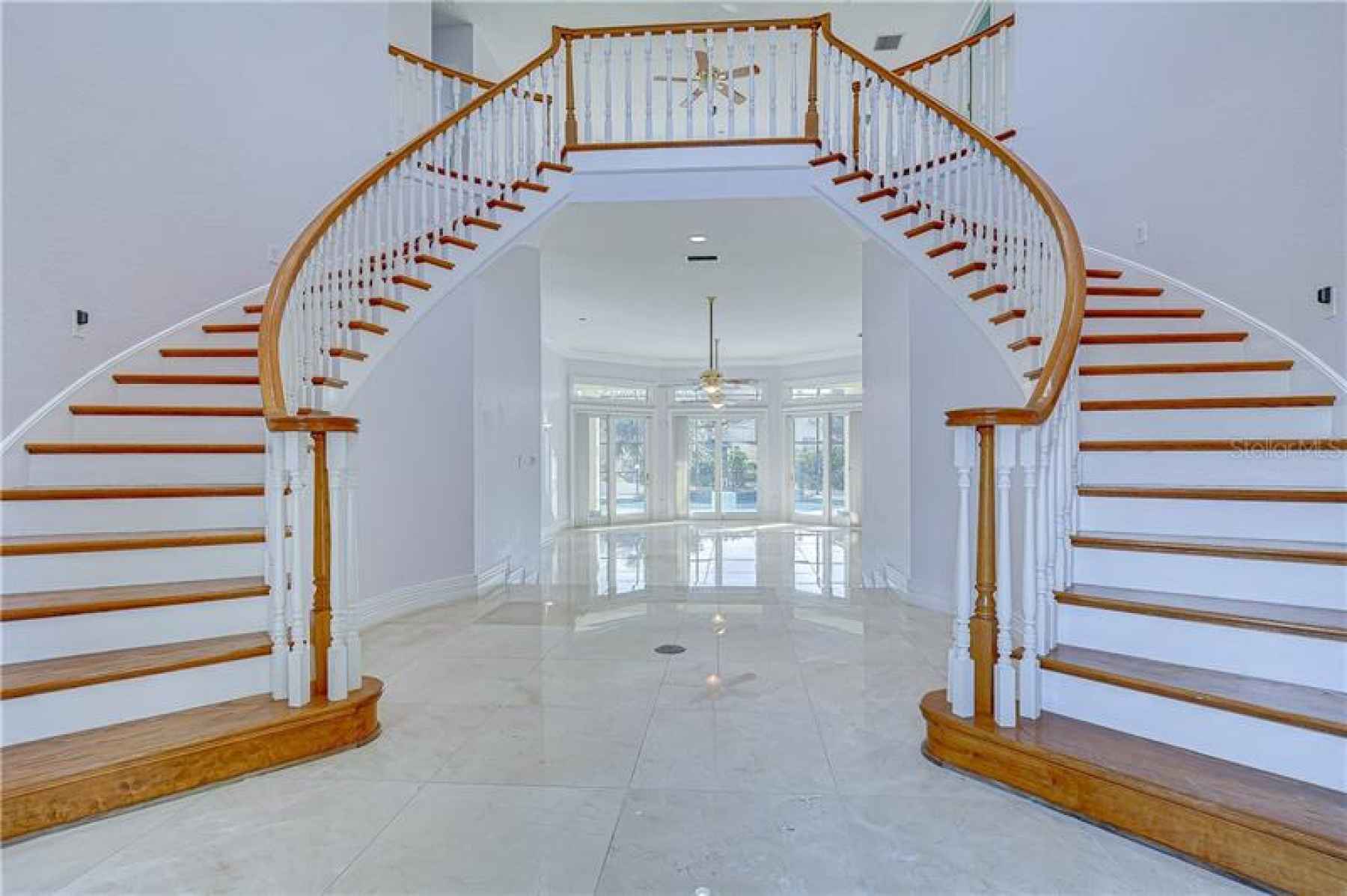 A stunning double staircase with a stunning chandelier will be there to greet you!