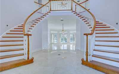A stunning double staircase with a stunning chandelier will be there to greet you!