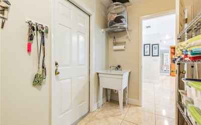 Laundry room with built-in ironing board and laundry chute from second floor.
