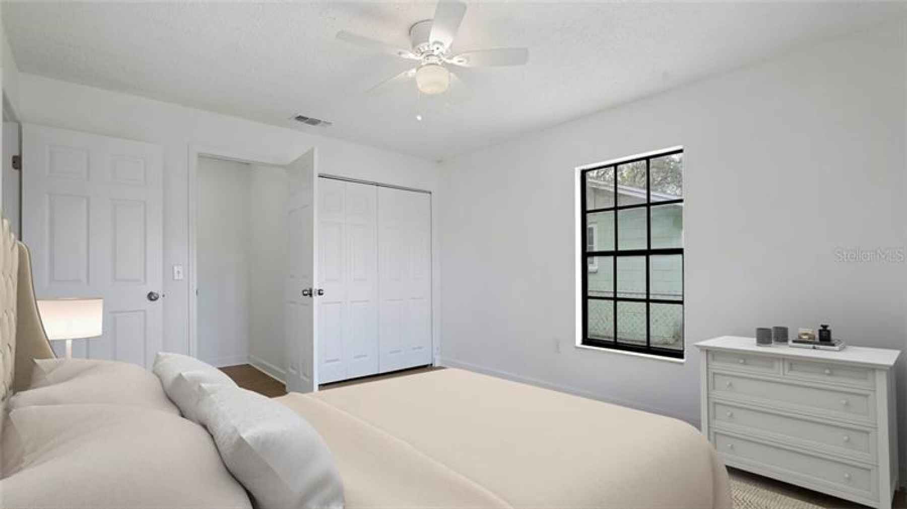 Staged master bedroom.  Open door is a large walk-in closet. (could be made into a 2nd bathroom if d