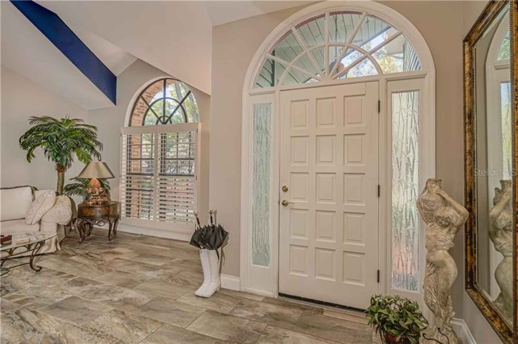 LARGE FOYER OPEN TO LIVING ROOM AND KITCHEN