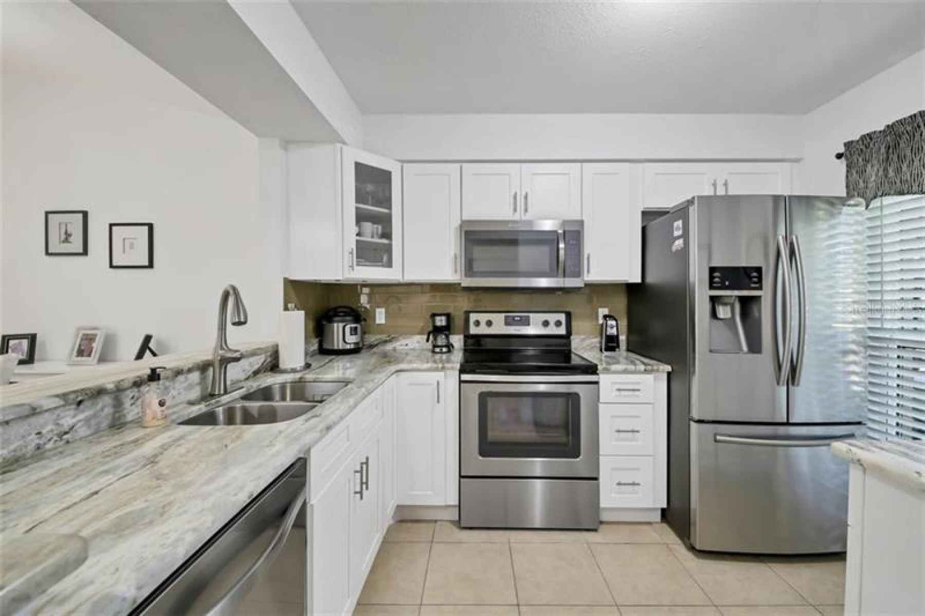 Gorgeous granite countertops, new white cabinetry, stainless appliances, new windows, new disposal