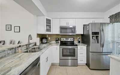 Gorgeous granite countertops, new white cabinetry, stainless appliances, new windows, new disposal
