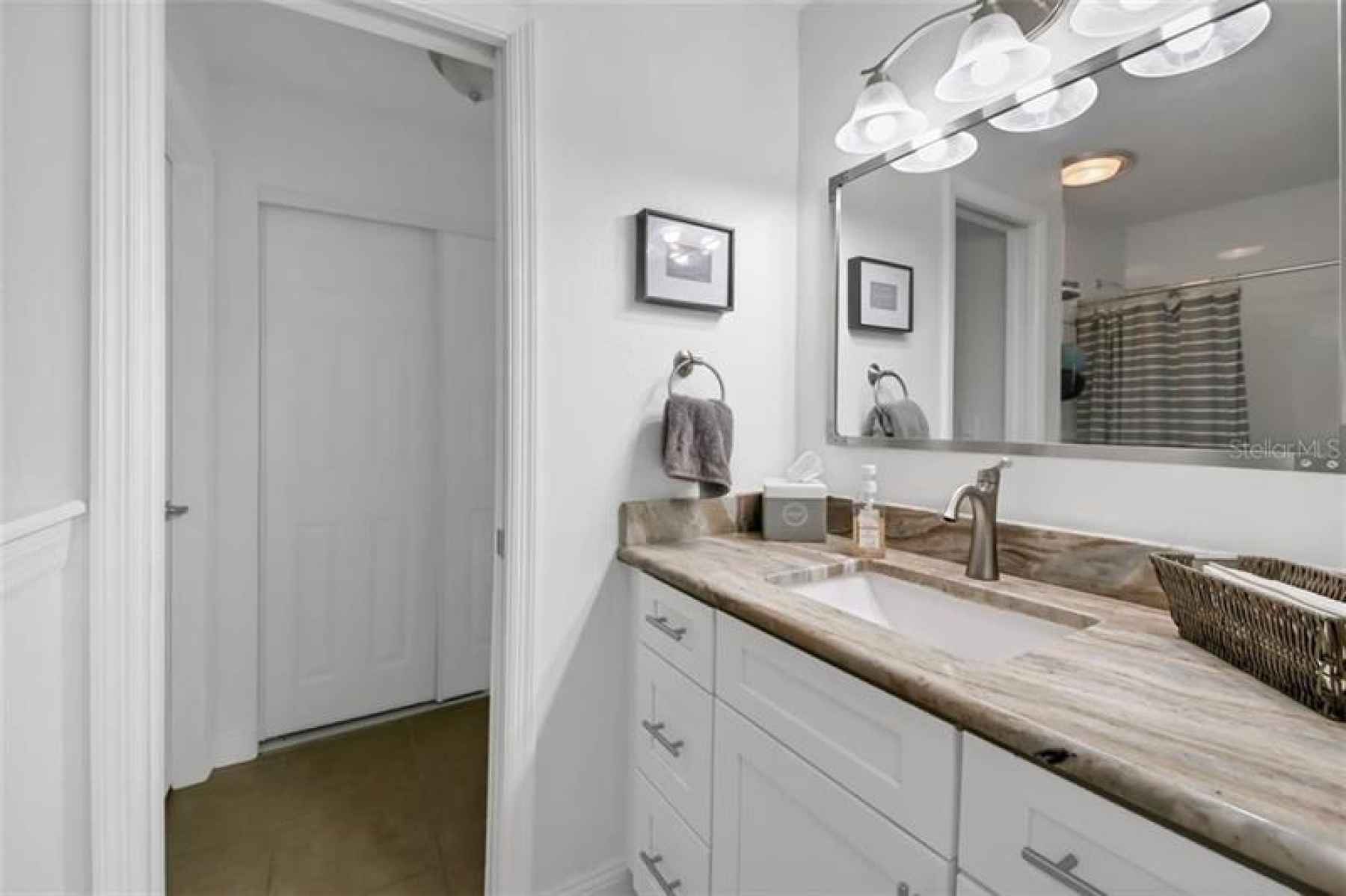 Completely remodeled bathroom with granite counter, new cabinetry, new lighting