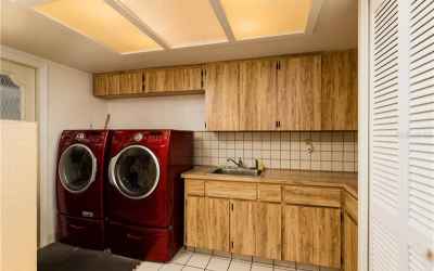 Huge laundry room with tons of storage and door out to the Pool!