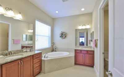 Huge master bath with two separate vanities, matching granite (as in the entire home) large tub and 