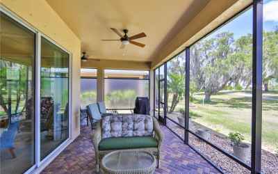 Large L-Shaped, screened lanai with permanent privacy screens and nothing but an expanse of green!