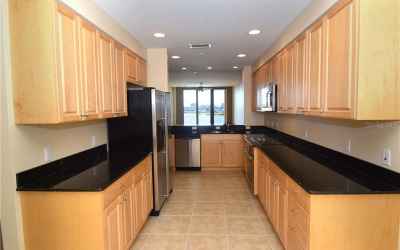 Kitchen with views of the river. Maple cabinets, SS appliances, granite counters.