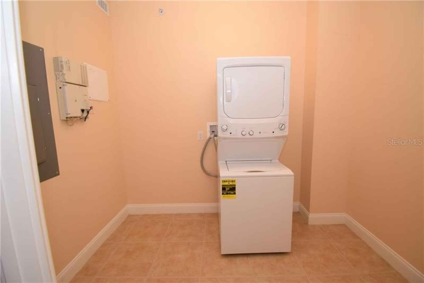 Laundry/utility room. New full size stack washer/dryer.