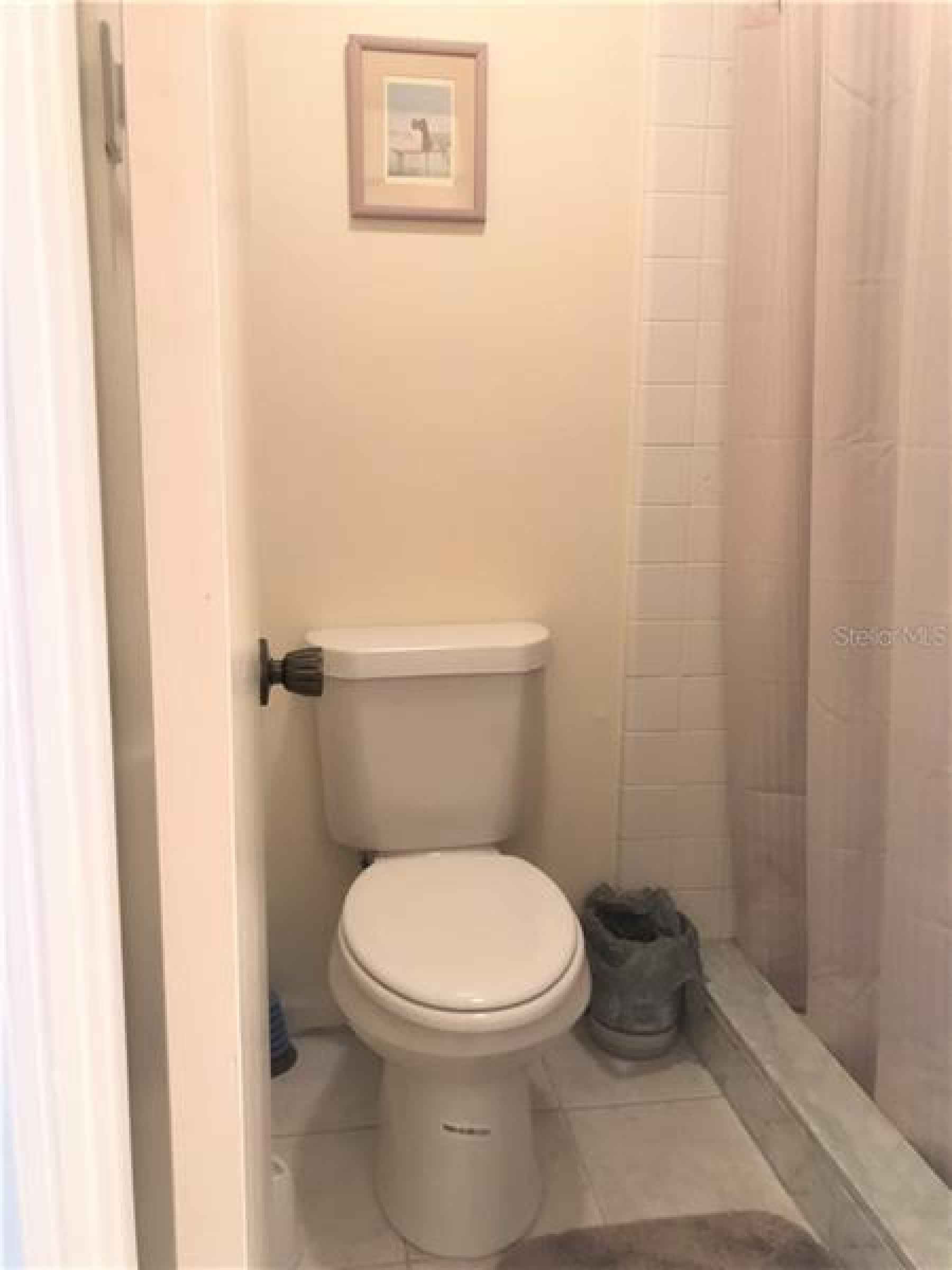 Master bathroom has a standup shower and toilet is in a room by itself