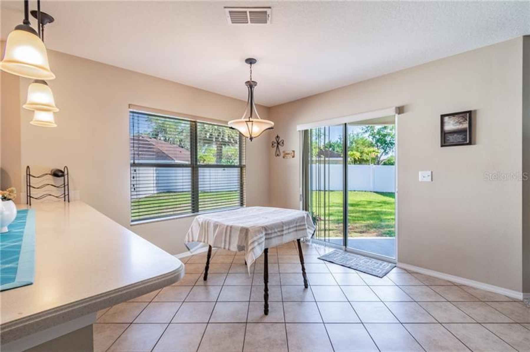 Dining room with doors leading to covered patio and fenced yard