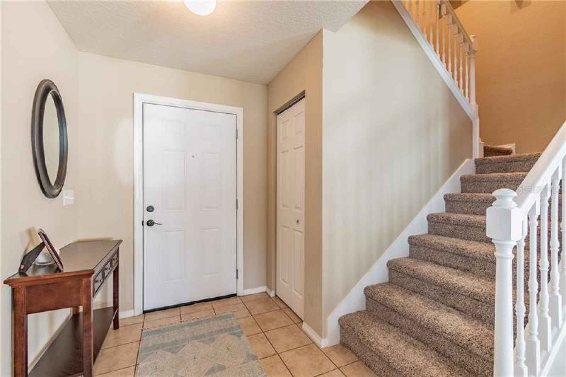 Entry Way is Tiled, Large under stairs Closet/storage. Brand new carpeting on the stairs