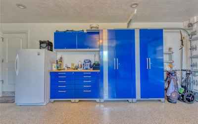 Immaculate garage with built-in cabinets and drawers for your tools.