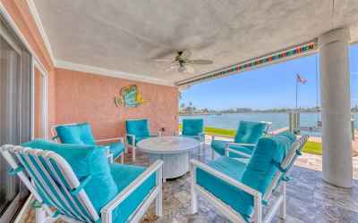 Covered entertainment lanai with a colorful pull-down shade.