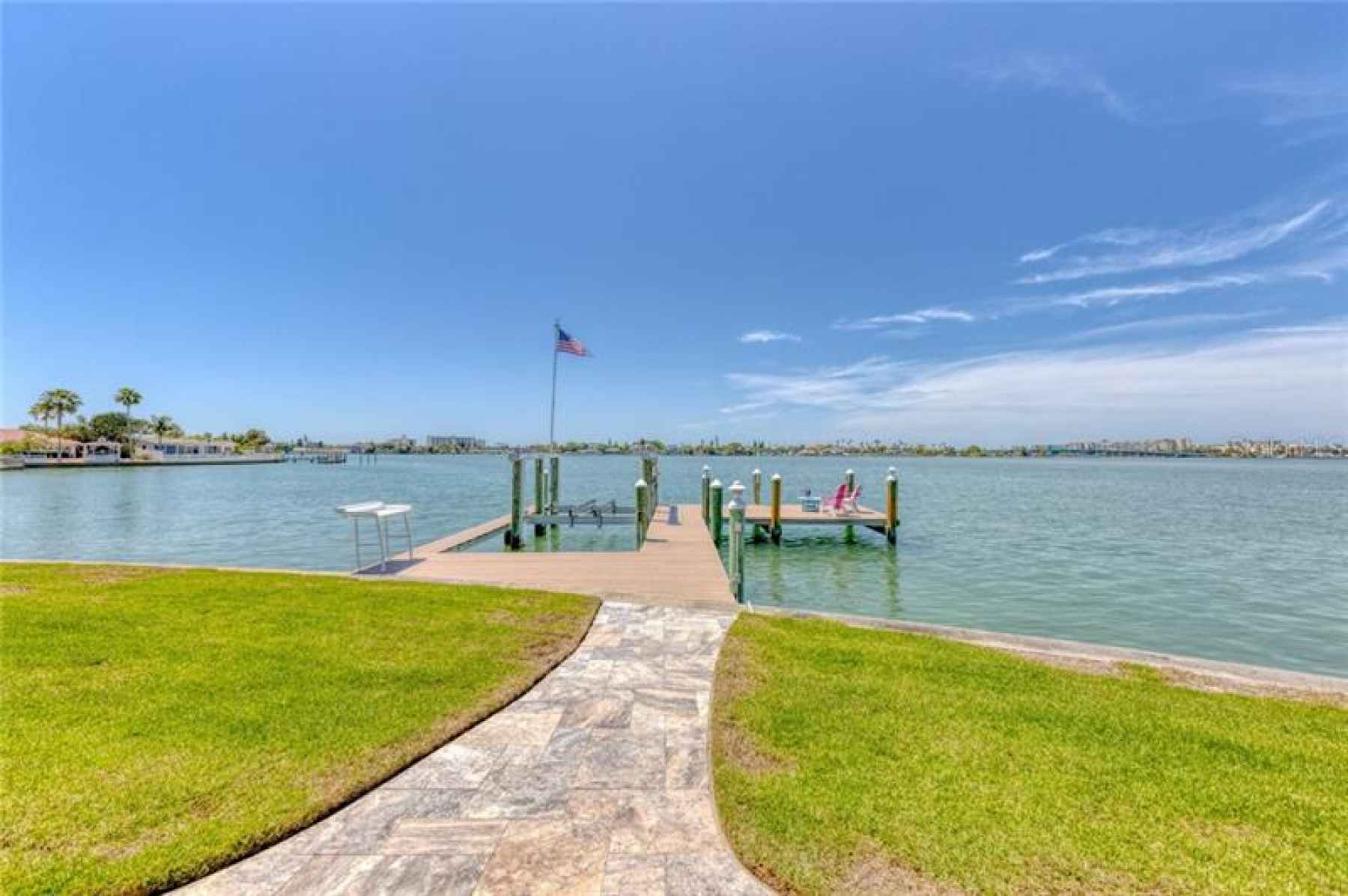Oversized L-shaped dock with an additional finger dock, a 16k boat lift, power & water.