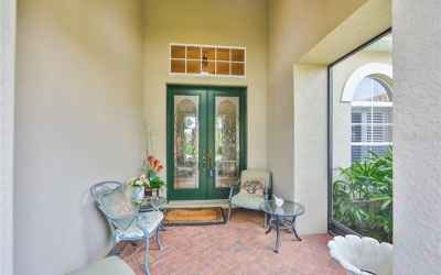 Beautifully covered front entrance, brick pavers and high ceilings with lovely lead glass doors to w