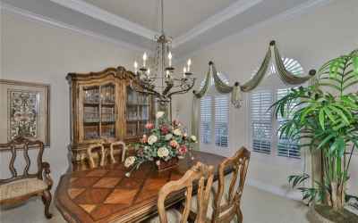 The Dining room boasts of plantation shutters, crown molding and a tray ceiling.