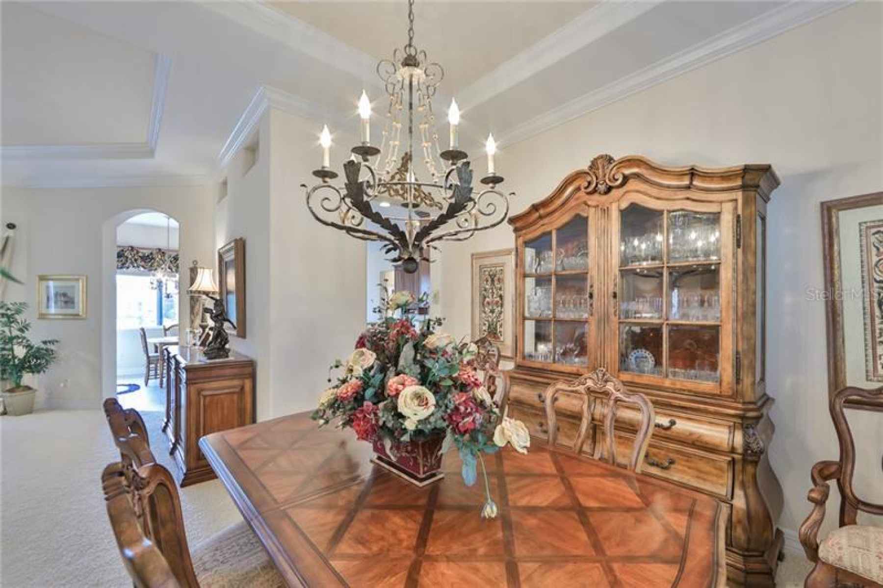 The Dining room is spacious and open to the rest of the house with handsome light fixtures.
