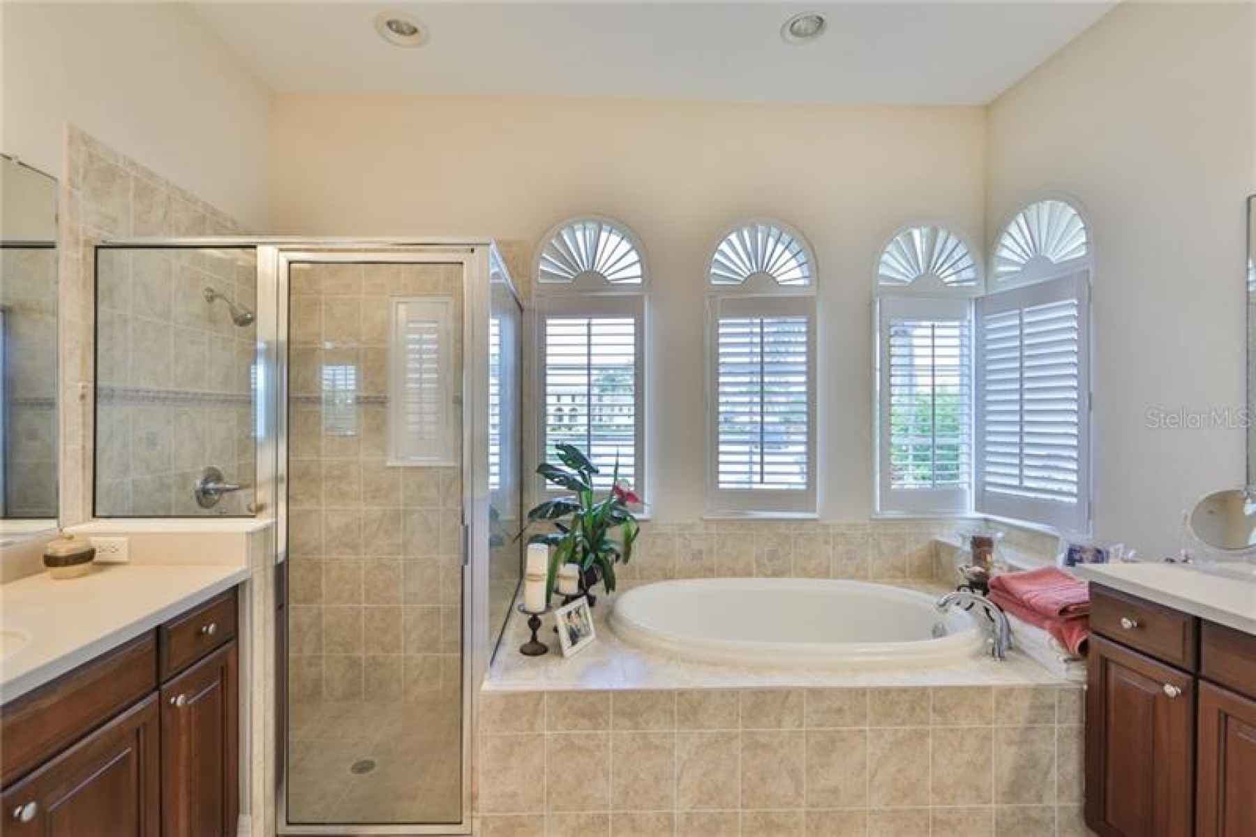 Master bath is large, with plantion shutters, soaking tub and dual vanities.