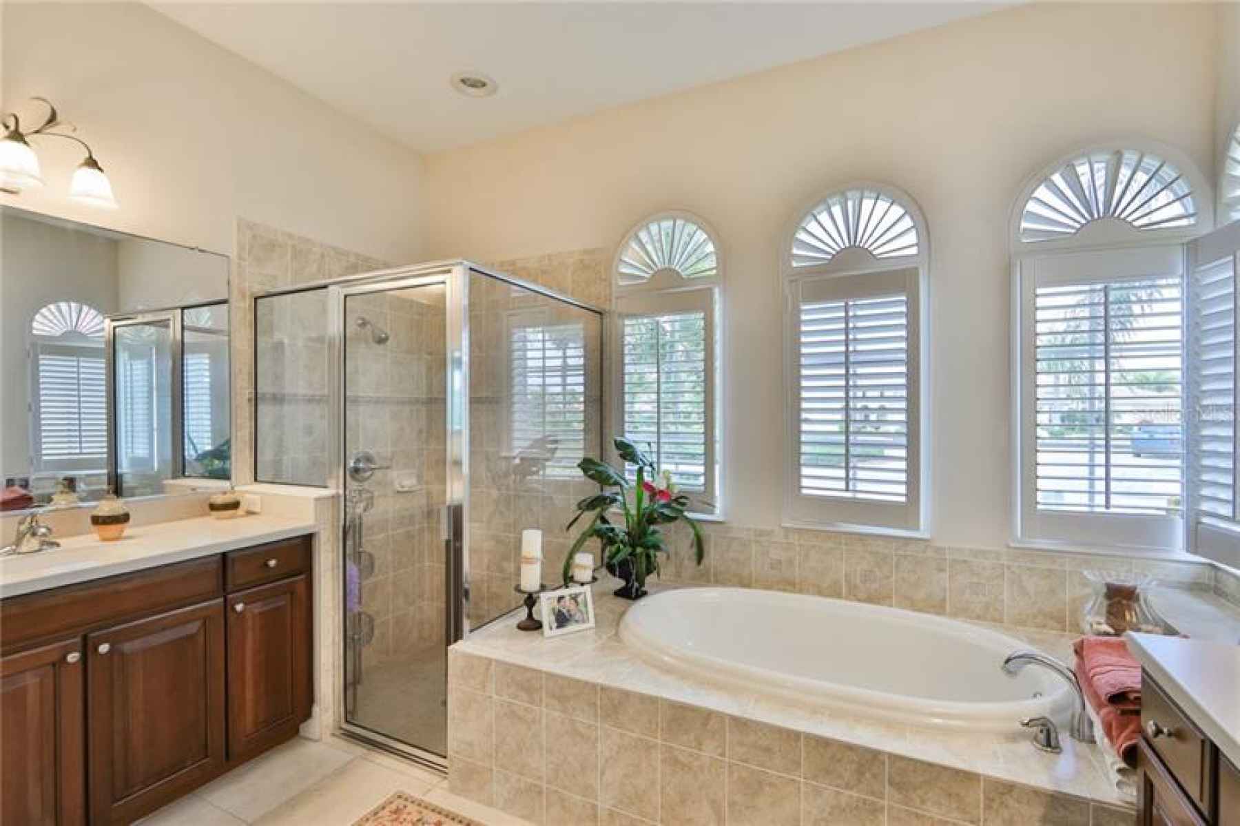 Brightly lit and spacious, this Master bathroom is simple elegance.
