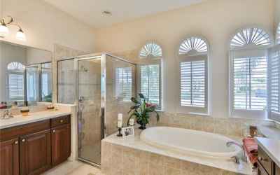 Brightly lit and spacious, this Master bathroom is simple elegance.